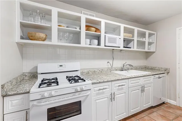 a kitchen with granite countertop cabinets and window
