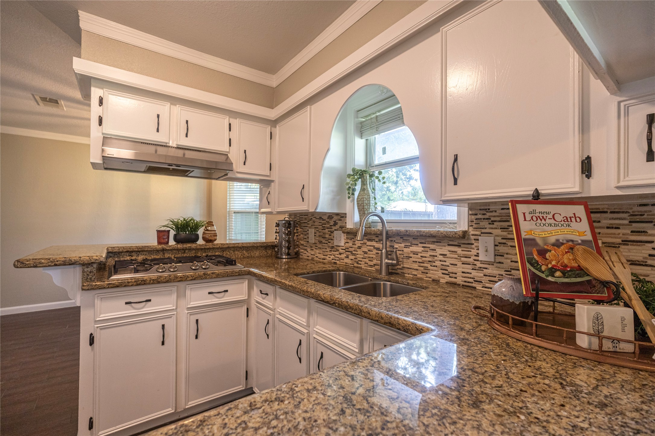 14419 Wadebridge Way Houston, TX 77015 - Photo 5 of 20 Natural light streams in through a window above the sink, creating a warm and inviting space.