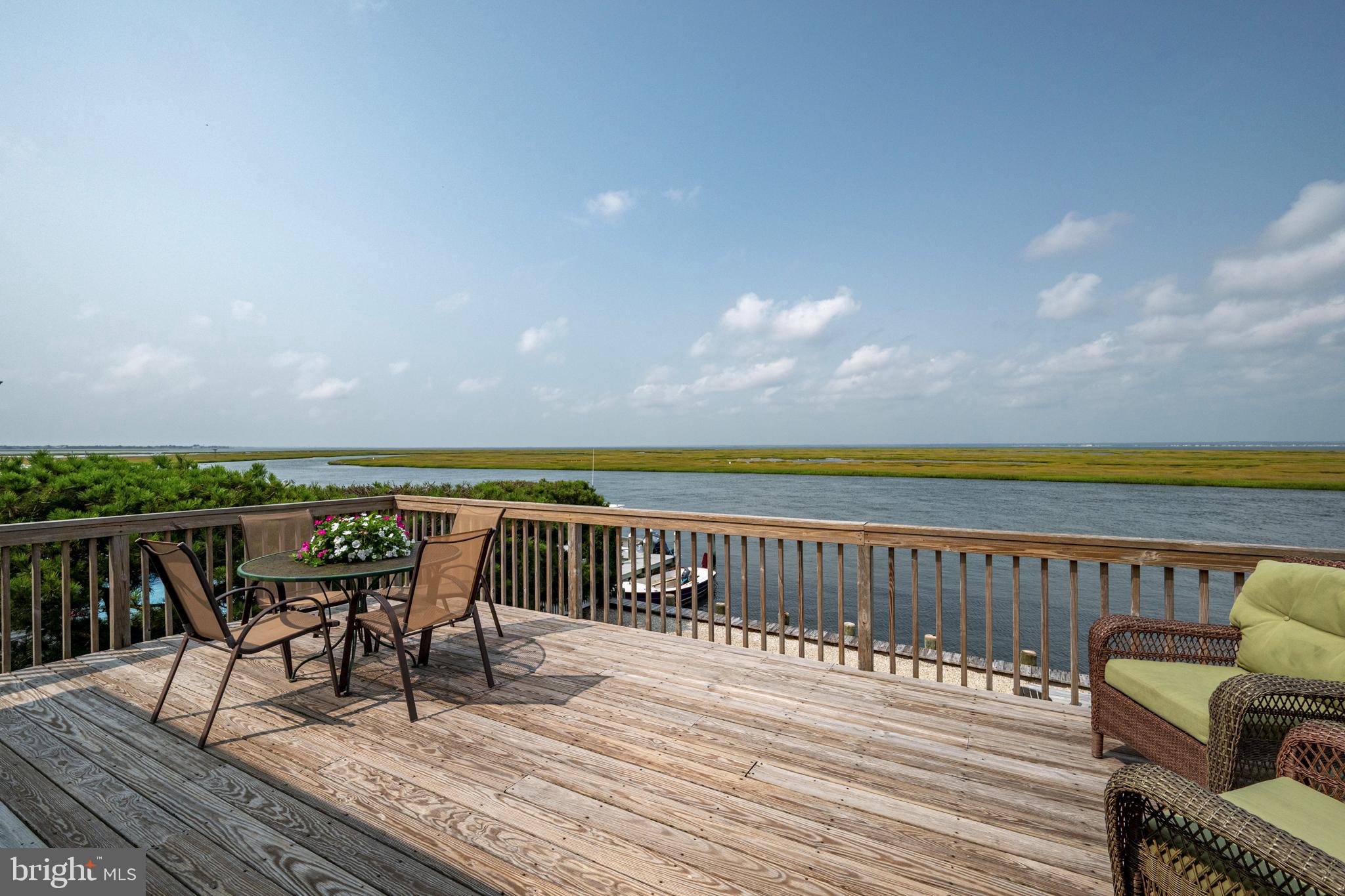 26 Butler Road Long Beach Township, NJ 08006 - Photo 11 of 44 a roof deck with chairs and wooden floor