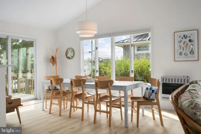 a living room with furniture and large windows