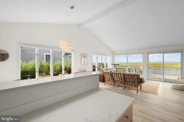 a view of a dining room with lots of white furniture