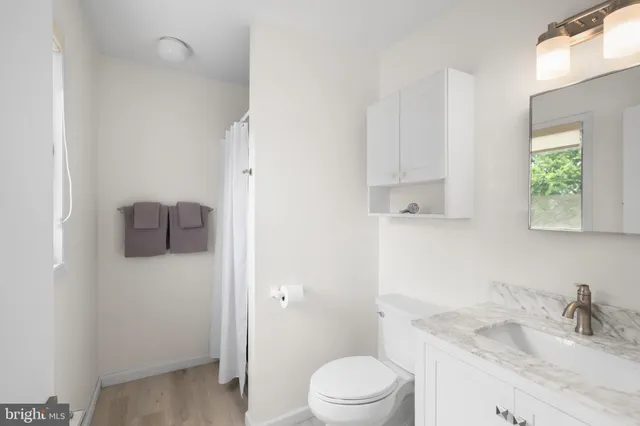 a bedroom with two beds and a chandelier