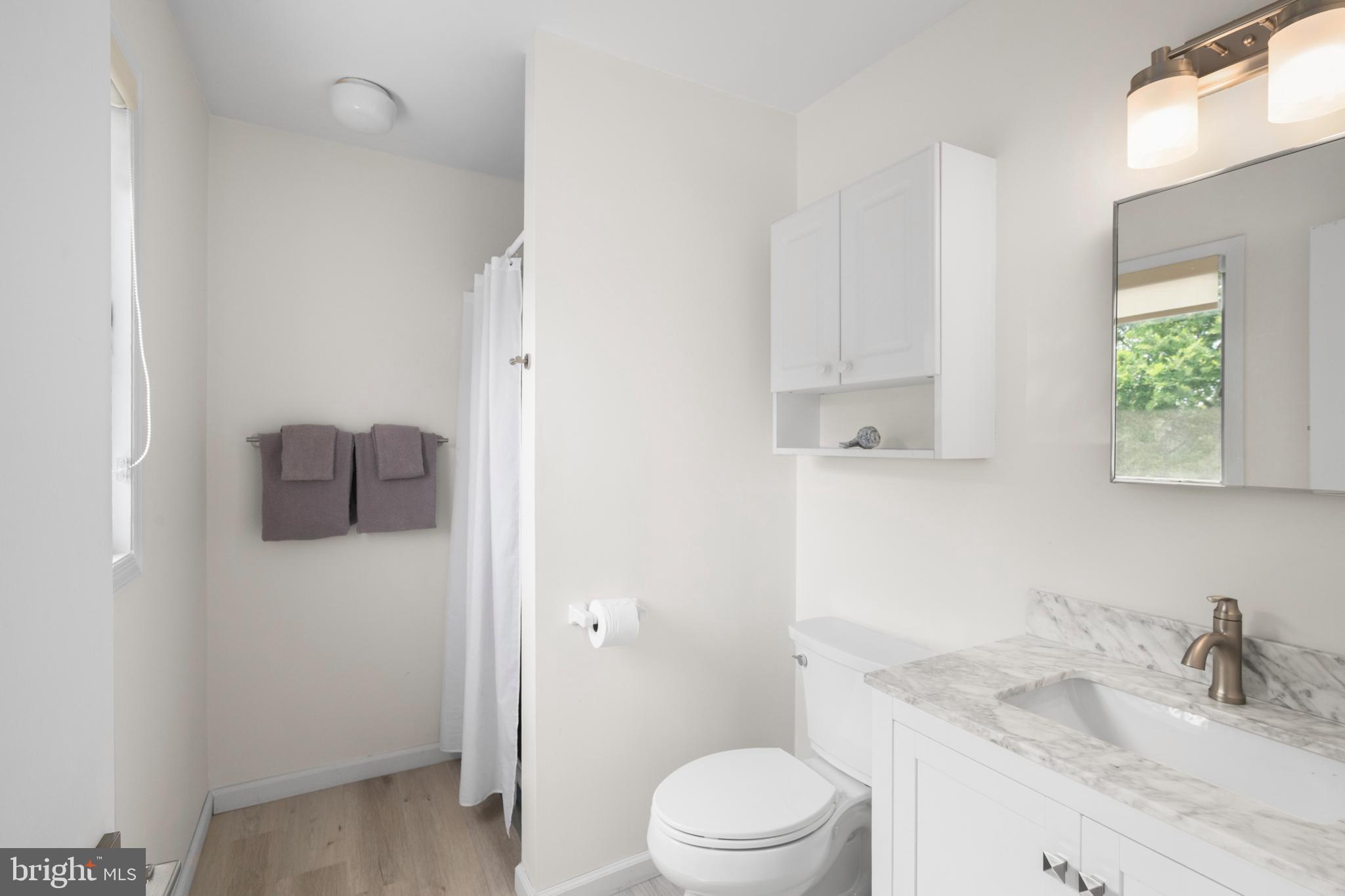 26 Butler Road Long Beach Township, NJ 08006 - Photo 29 of 44 a bathroom with a granite countertop sink toilet and shower