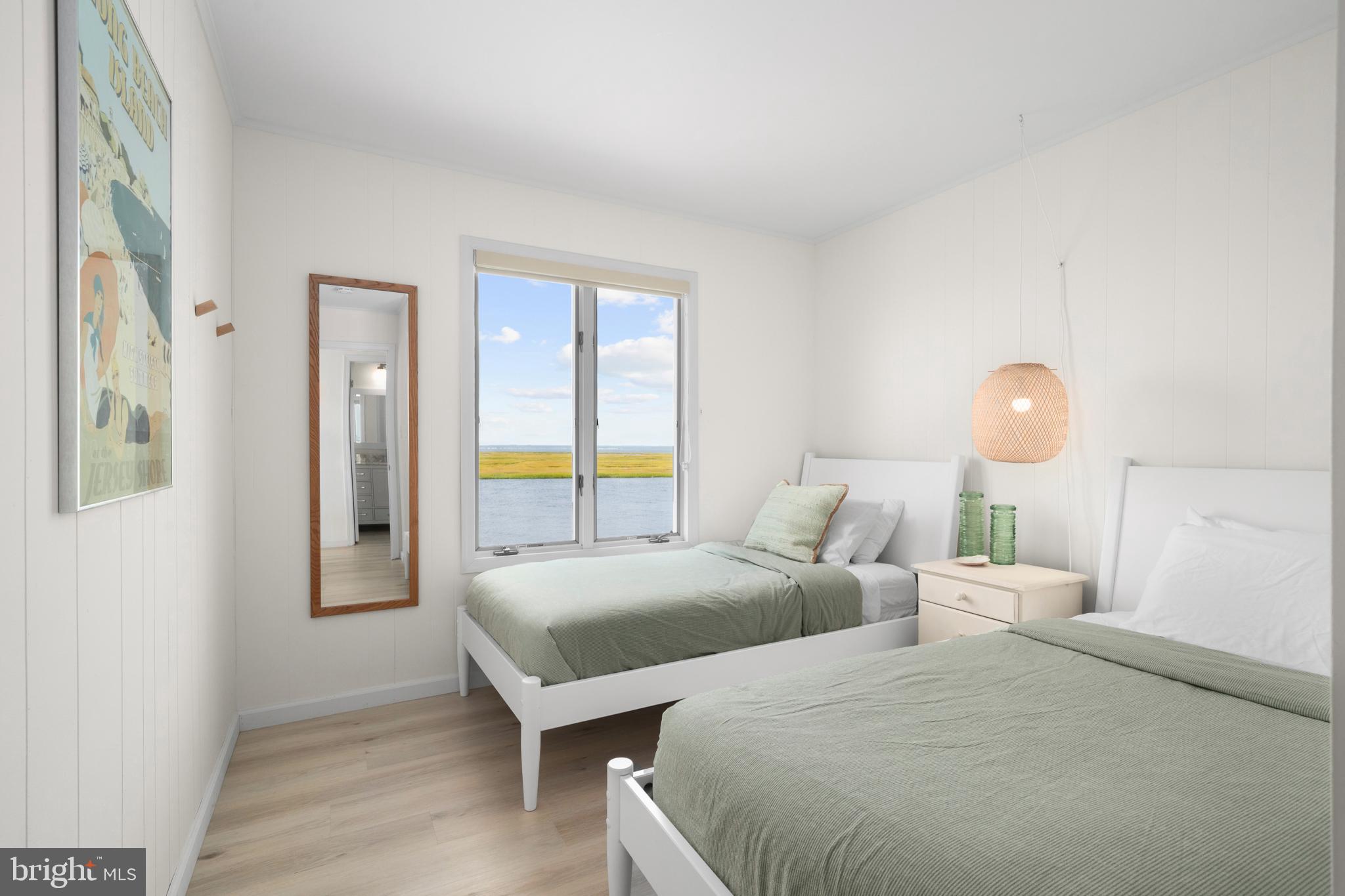 26 Butler Road Long Beach Township, NJ 08006 - Photo 31 of 44 a bedroom with two beds and a chandelier