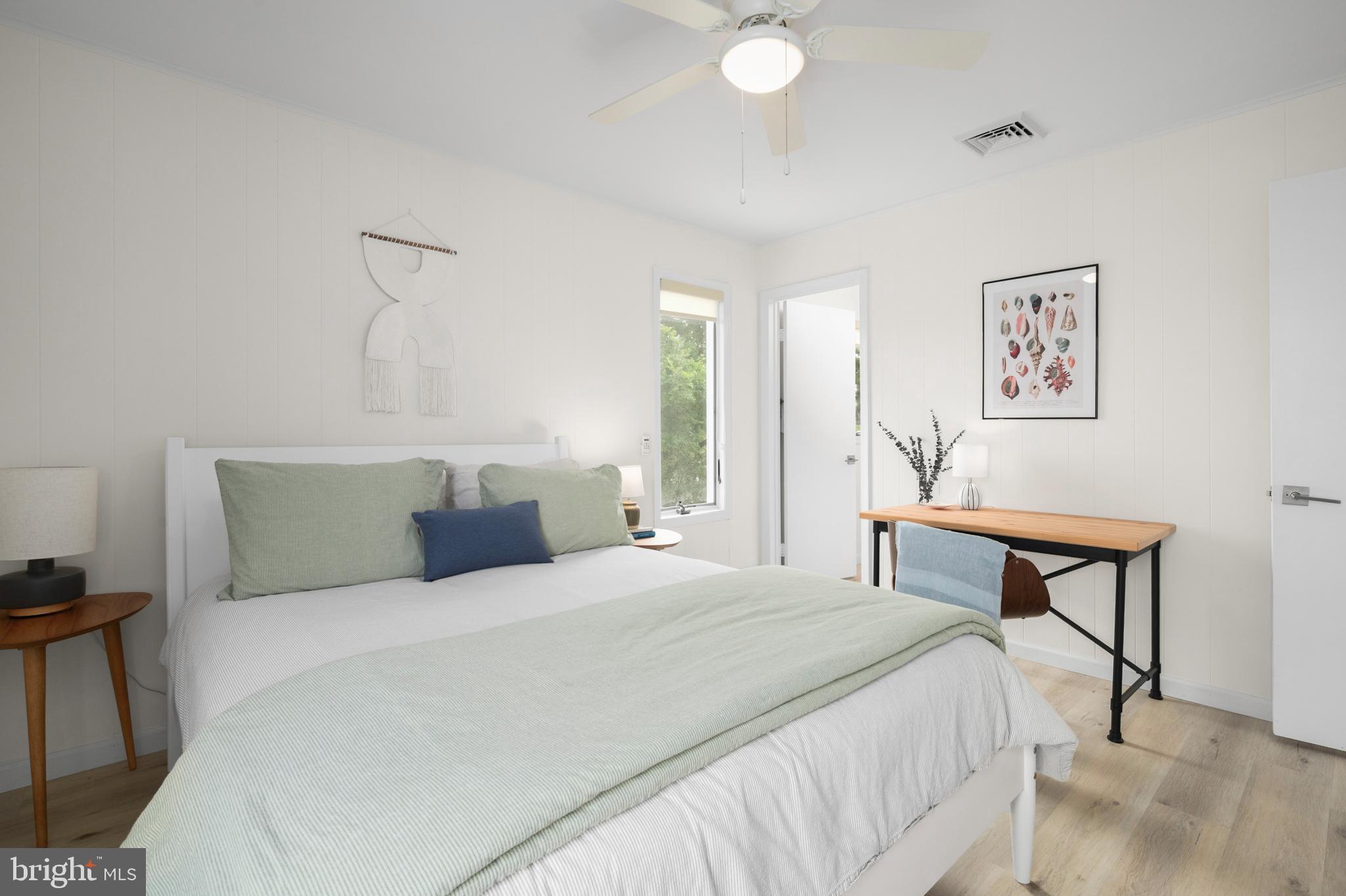 26 Butler Road Long Beach Township, NJ 08006 - Photo 34 of 44 a bedroom with a bed and a painting on the wall