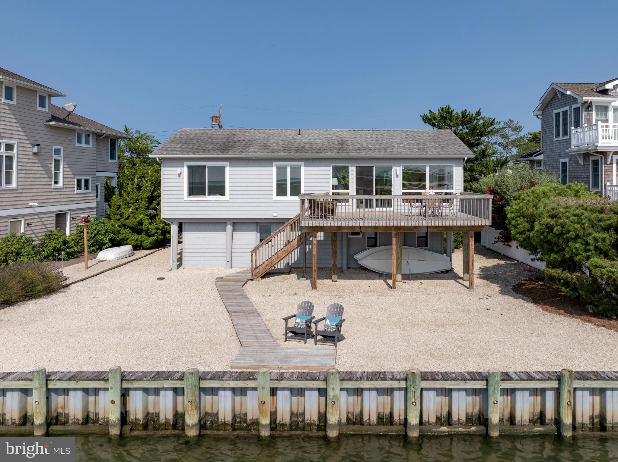 26 Butler Road Long Beach Township, NJ 08006 - Photo 38 of 44 a view of a house with backyard porch and sitting area