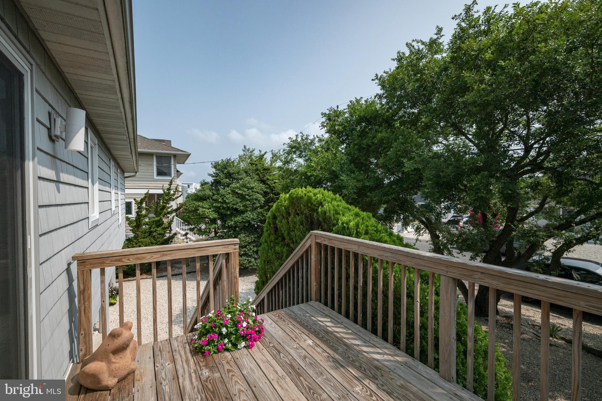 26 Butler Road Long Beach Township, NJ 08006 - Photo 7 of 44 a balcony with wooden floor and outdoor space