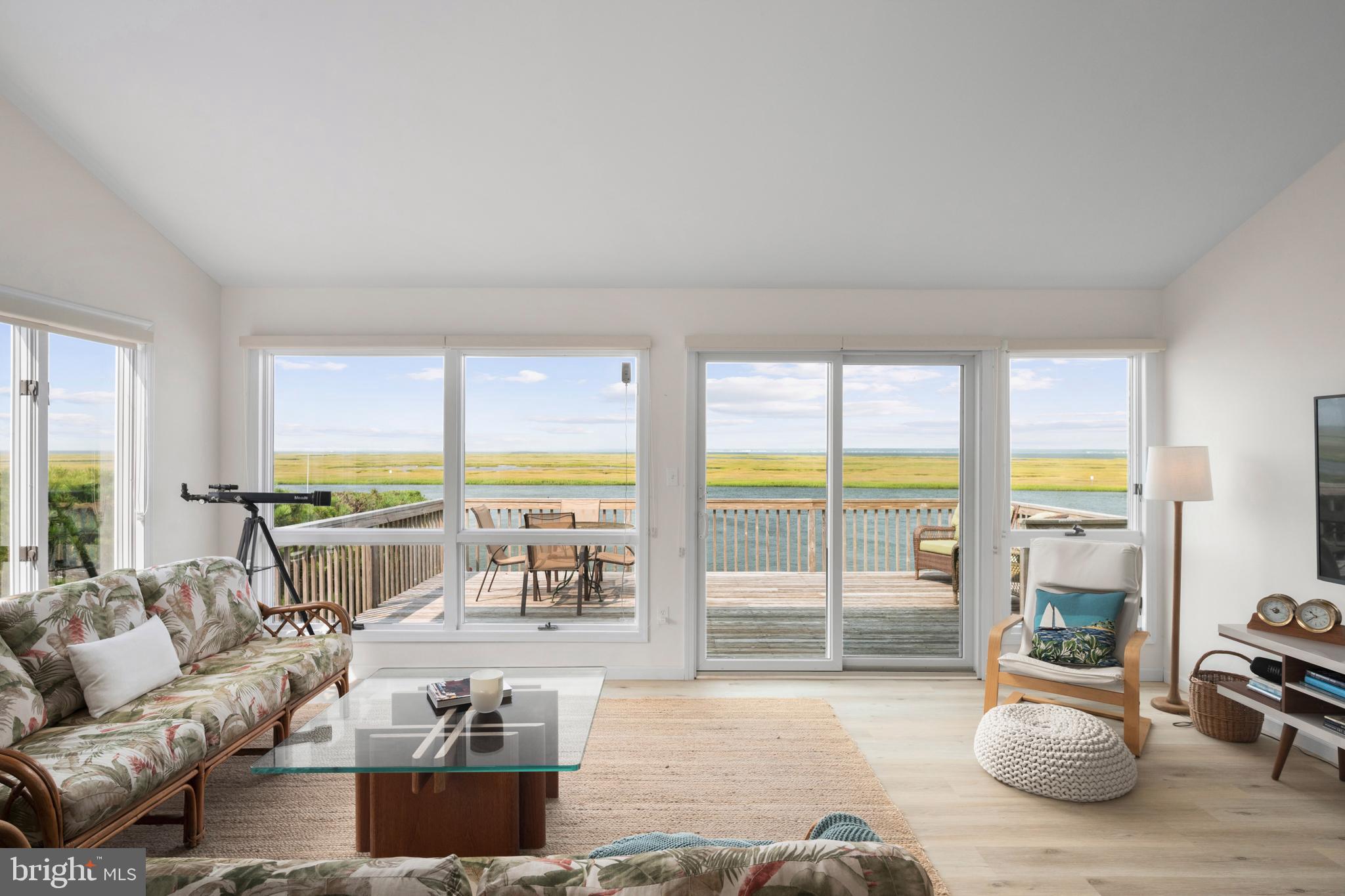 26 Butler Road Long Beach Township, NJ 08006 - Photo 8 of 44 a living room with furniture and a floor to ceiling window
