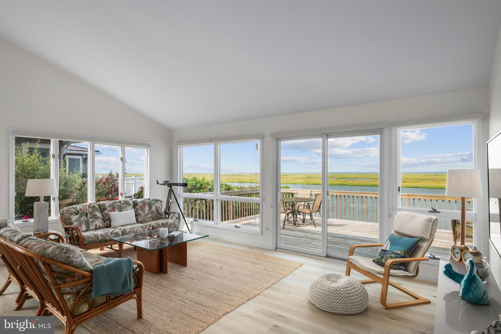 26 Butler Road Long Beach Township, NJ 08006 - Photo 9 of 44 a living room with furniture and a large window with balcony view