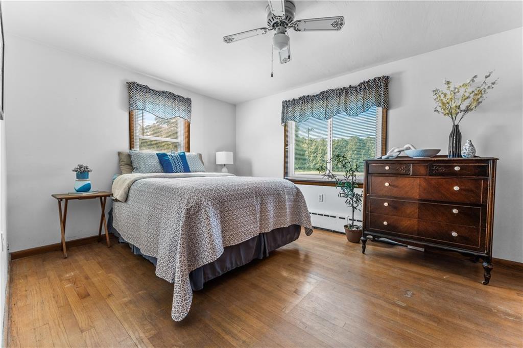 3434 Mitchell Road New Castle, PA 16105 - Photo 6 of 10 a bedroom with a bed and a potted plant