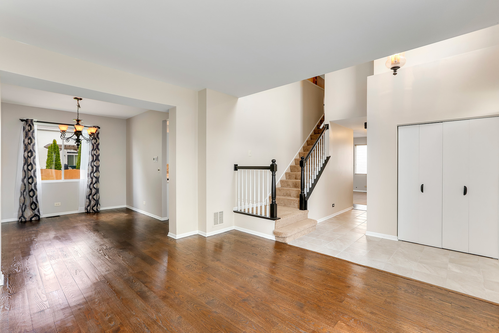 24340 Hemlock Drive Plainfield, IL 60585 - Photo 3 of 33 a view of a livingroom with wooden floor and stairs
