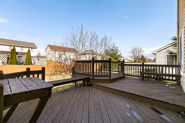 24340 Hemlock Drive Plainfield, IL 60585 - Photo 30 of 33 a balcony with wooden floor table and chairs