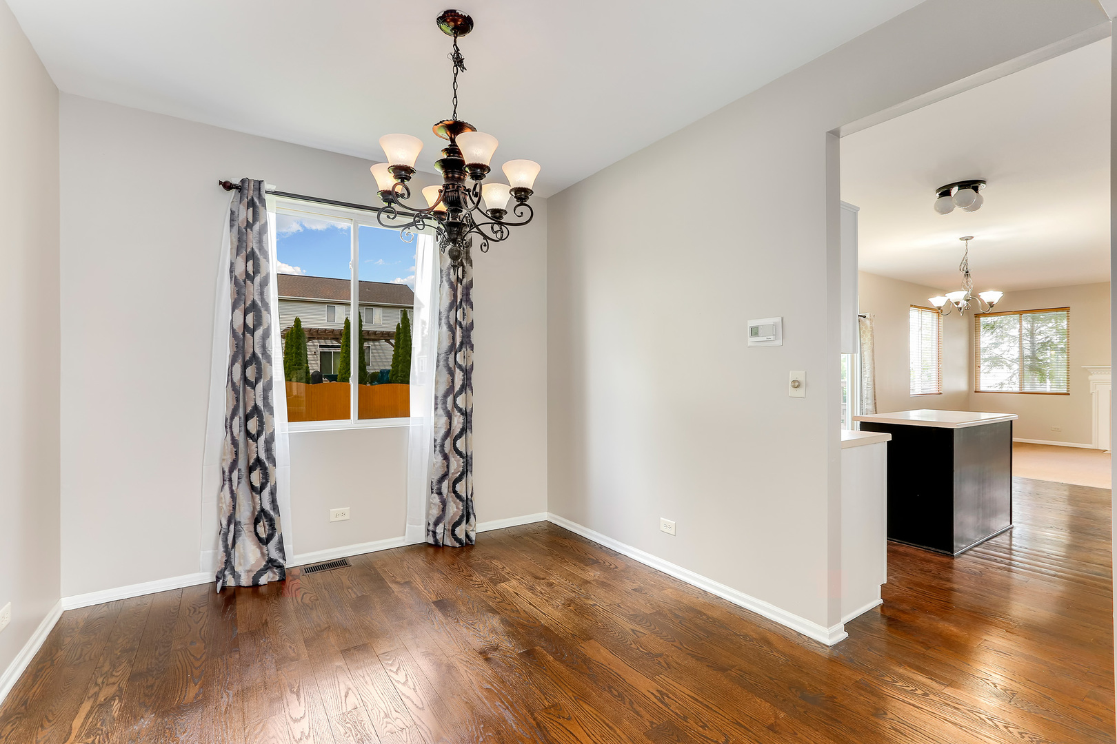 24340 Hemlock Drive Plainfield, IL 60585 - Photo 5 of 33 a view of an empty room with window and wooden floor
