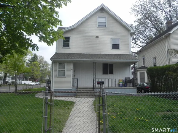 a front view of house with yard and green space