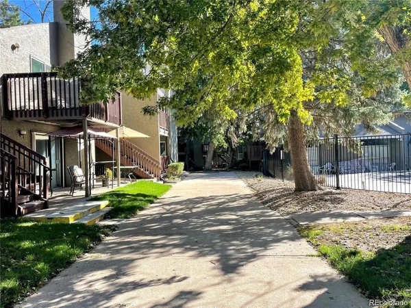 a view of a house with a tree in front