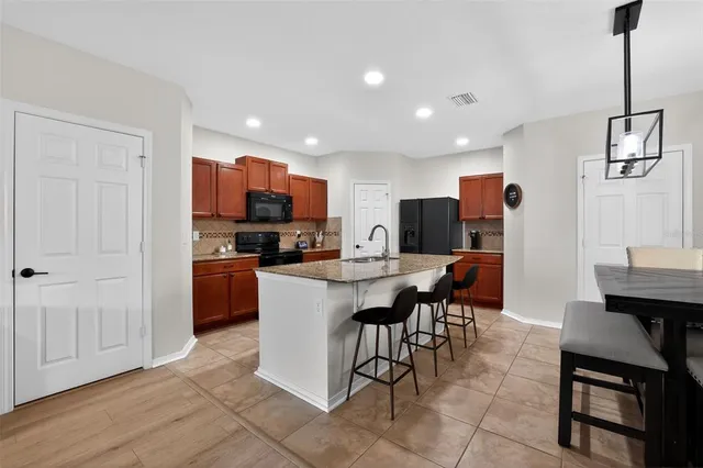 a large kitchen with a table and chairs in it