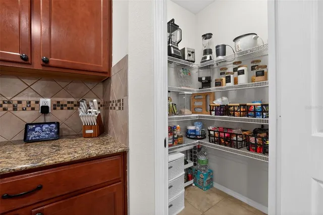 a kitchen with refrigerator and cabinets
