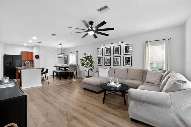a living room with furniture and kitchen view