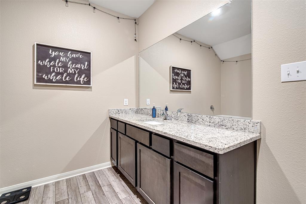 1813 Rialto Lane Crowley, TX 76036 - Photo 18 of 27 a bathroom with a sink and a mirror