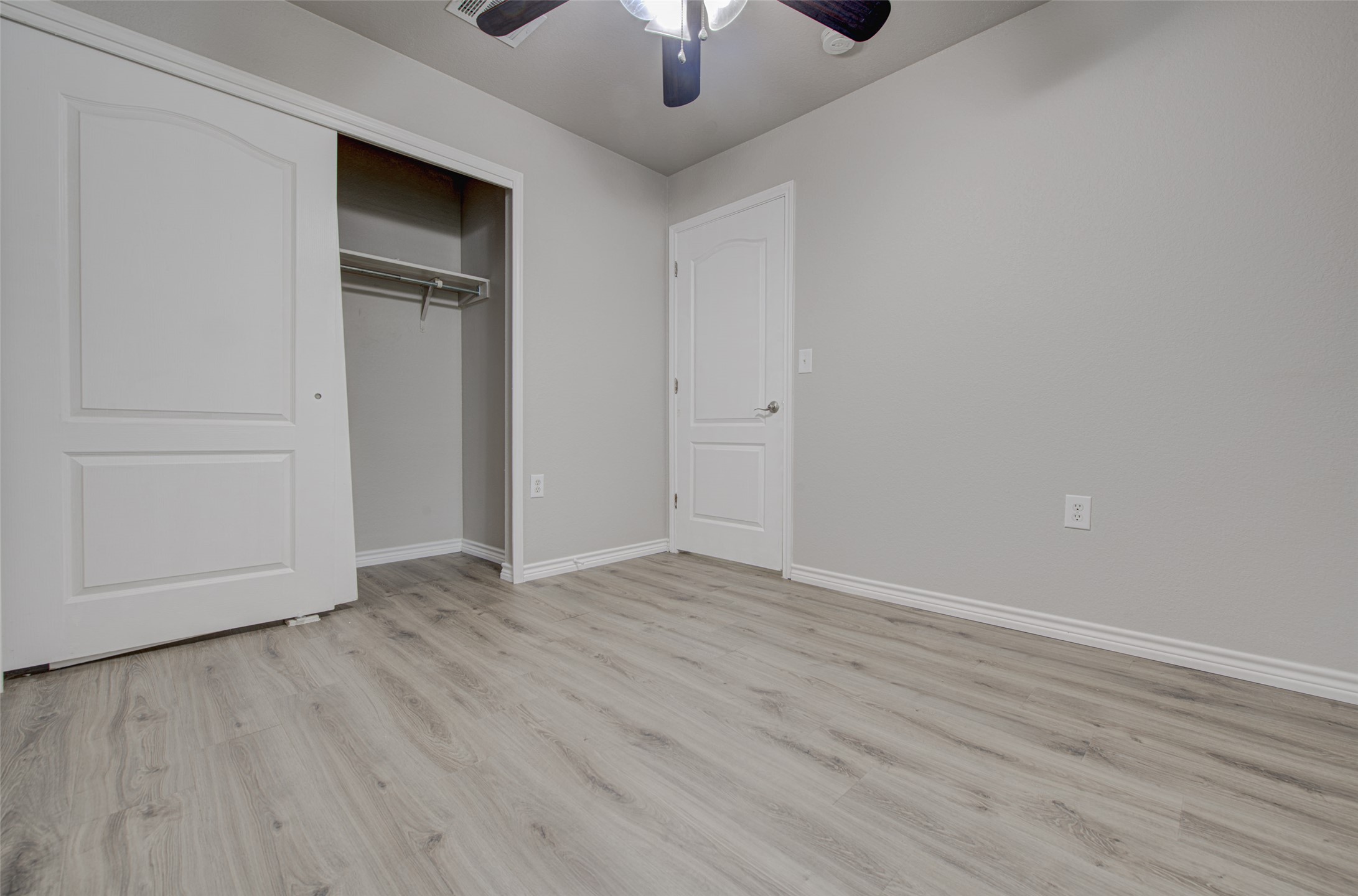 6709 Doyal Drive Austin, TX 78747 - Photo 14 of 22 Unfurnished bedroom with a closet, light wood-type flooring, and a ceiling fan