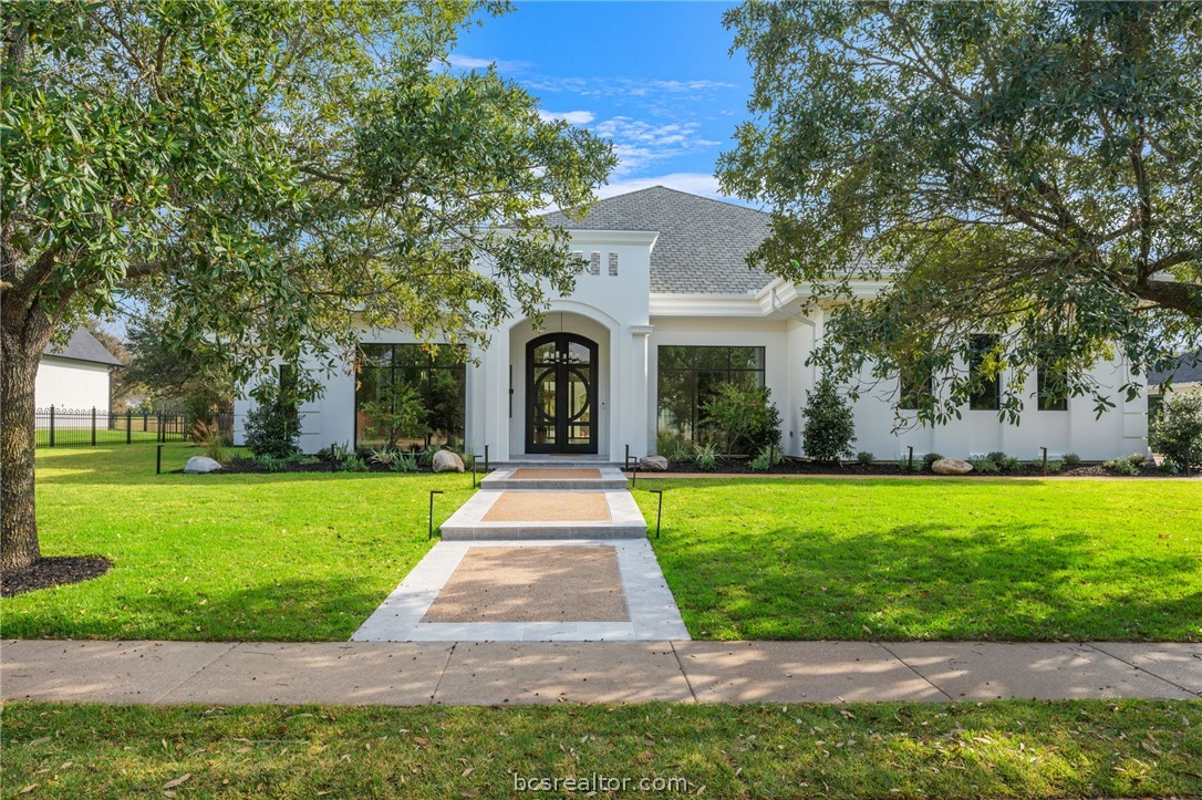 4212 Tuscany Court Bryan, TX 77802 - Photo 2 of 41 a front view of a house with garden