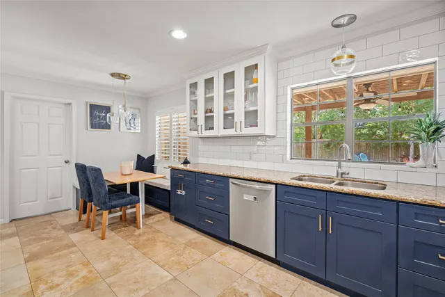 a kitchen with a sink and wooden cabinets