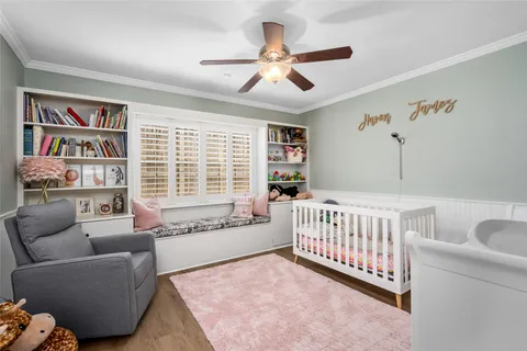 a living room with furniture and a book shelf