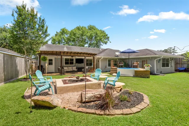 a view of a house with backyard sitting area and swimming pool