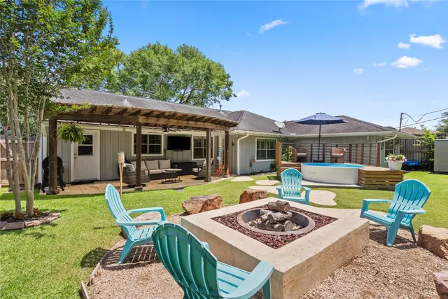 a view of a house with backyard sitting area and swimming pool