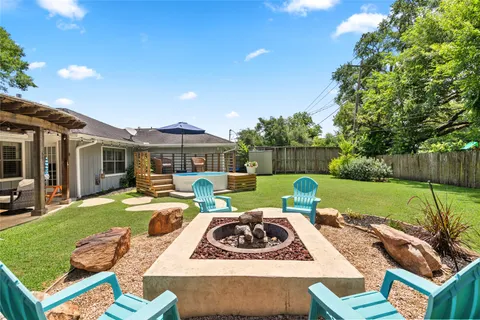 a view of a house with backyard sitting area and swimming pool