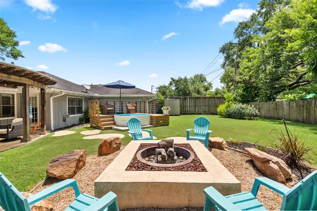 a view of a house with backyard sitting area and swimming pool