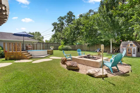 a view of a chair and table in the garden