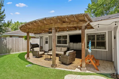 a view of a house with backyard porch and sitting area