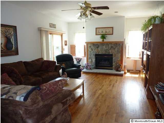 331 Frank Applegate Road Jackson, NJ 08527 - Photo 3 of 3 a living room with furniture and a fireplace