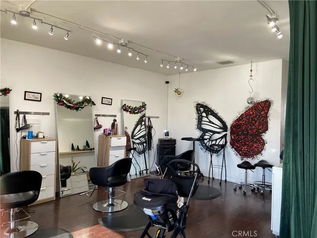 a living room with furniture a rug and white walls