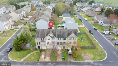 an aerial view of residential houses with outdoor space and swimming pool