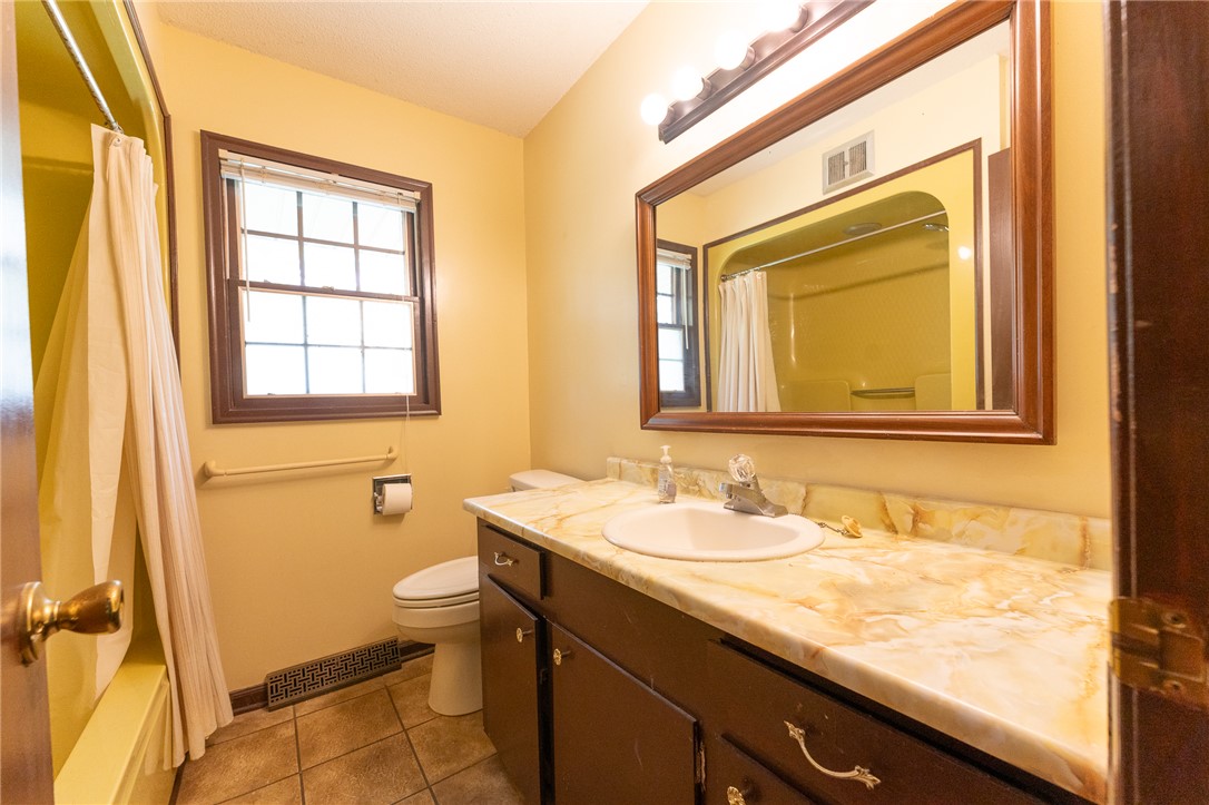 139 Todds Creek Road Central, SC 29630 - Photo 44 of 45 This bathroom features a single vanity, a toilet, and a combination shower and tub.