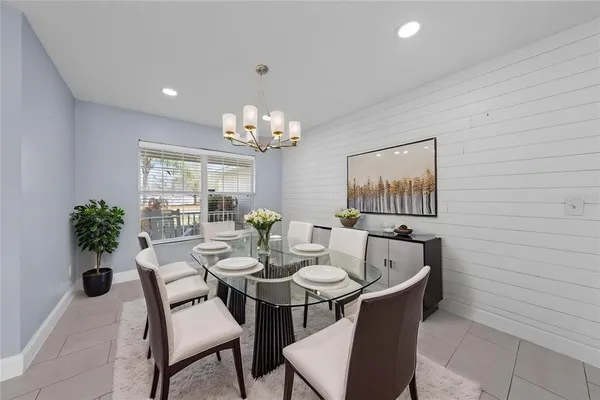 a view of a dining room with furniture and chandelier