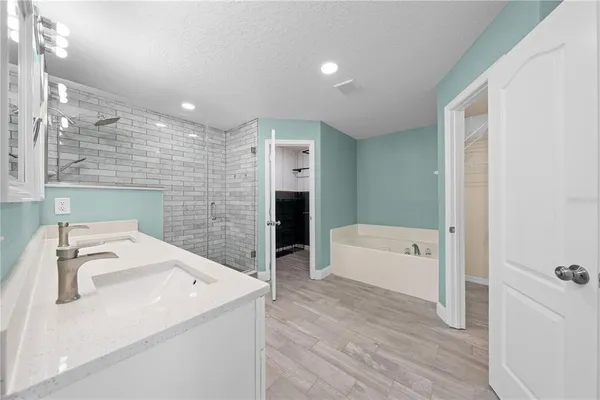 a bathroom with a sink a bathtub and a shower