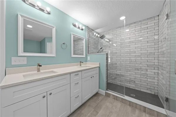 a bathroom with a double vanity sink mirror and double