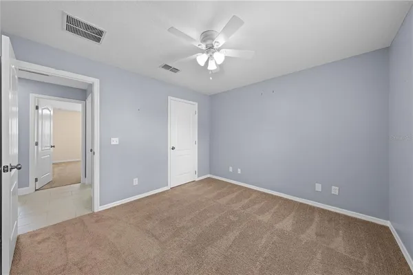 a view of an empty room with a fan