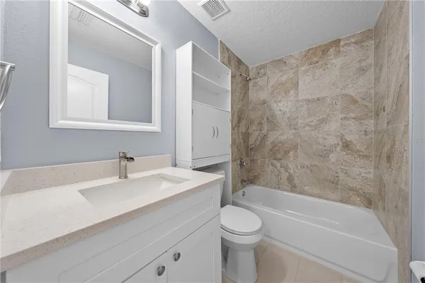 a bathroom with a sink a toilet and a bathtub