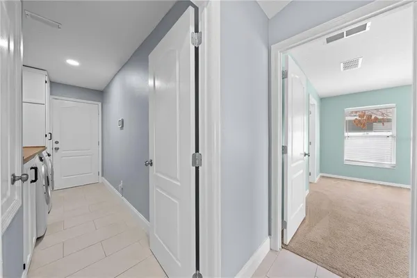 a view of a hallway with closet and a livingroom view