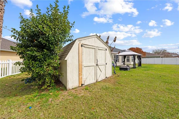 a view of backyard of house with green space