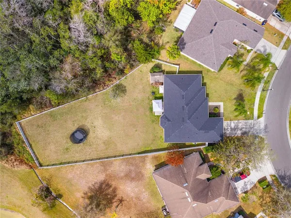 an aerial view of residential house with outdoor space and swimming pool