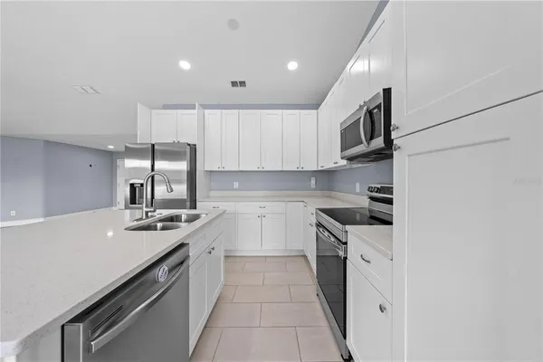 a kitchen with a sink stove and refrigerator