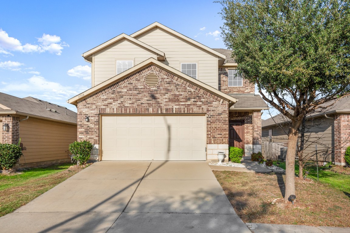 14504 Callan Court Manor, TX 78653 - Photo 1 of 22 a front view of a house with a yard and garage