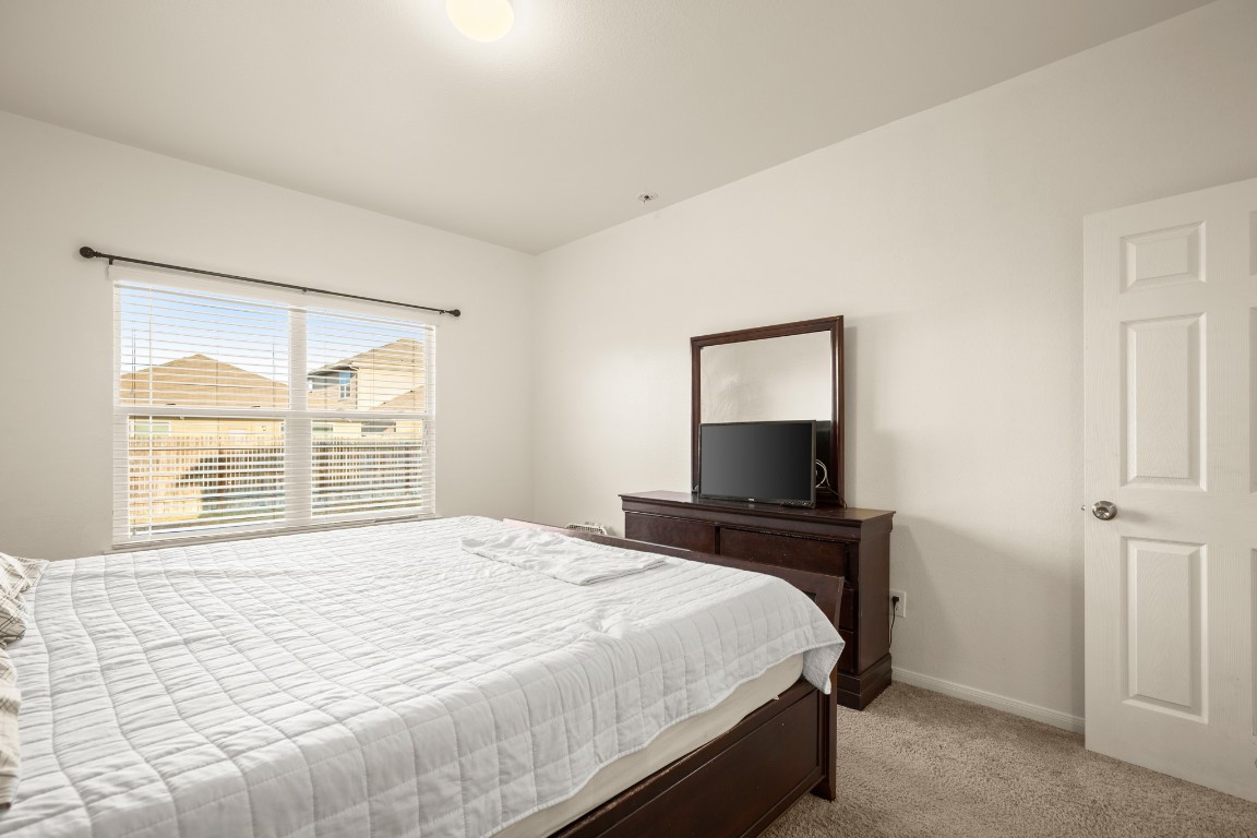 14504 Callan Court Manor, TX 78653 - Photo 11 of 22 a bedroom with a bed and a window