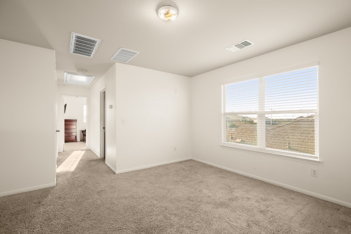 14504 Callan Court Manor, TX 78653 - Photo 16 of 22 an empty room with a empty space and windows