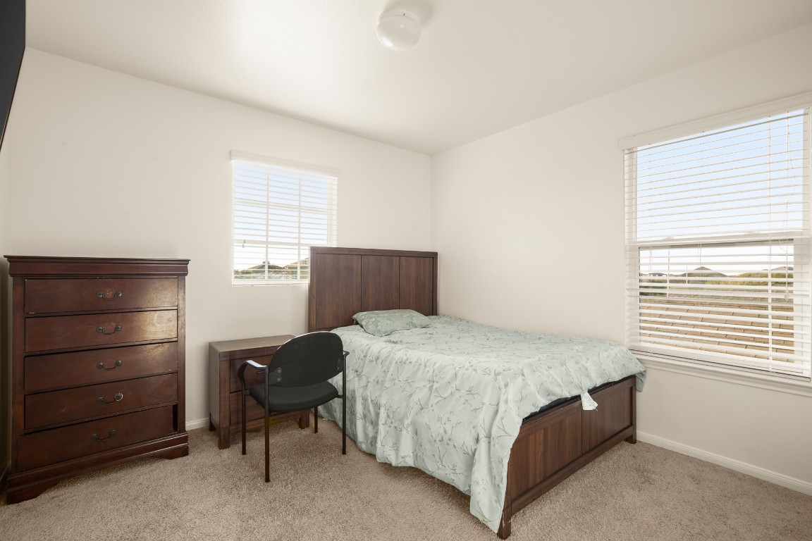 14504 Callan Court Manor, TX 78653 - Photo 18 of 22 a bedroom with a bed and a window